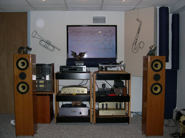 On the left: Audio Prism Mantissa, Empiracal Audio modded Sony DVP-7700 as transport into a self modded ART DI/O DAC, near rev-A self modded McCormack DNA .5. On the right: DIY Turntable with Corian plinth, Hagerman Coronet, Jon Risch power conditioner and Mantissa outboard power supply. Audio Prism Debut II amp. All sitting on my DIY seismic sink racks (50lbs of sand in each shelf). That's a Rel Strata III sub in the back with a Teac 2340 4 channel R-2-R on top.