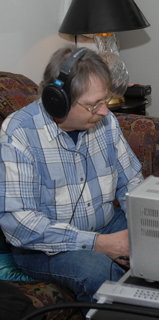 Chris listening to what looks like Bob's Sennheiser 600 headphones