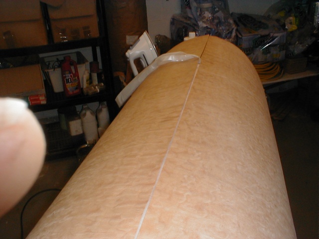 Wax paper prevents accidental glue down. Two sides are overlaped then cut simultaniously with a straightedge and exacto knife.