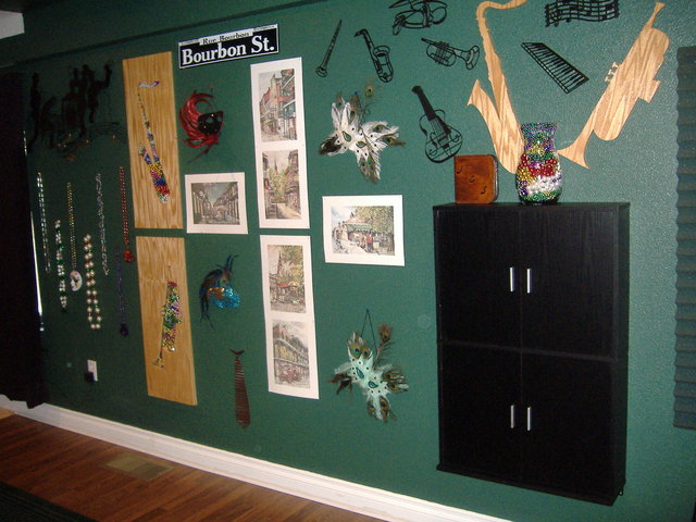 Soundroom - View of the 2004 Mardi Gras wall from our visit. The wood sax and trumpet are scroll saw shapes set into the wall cavity with hundreds of our beads in the cavity.