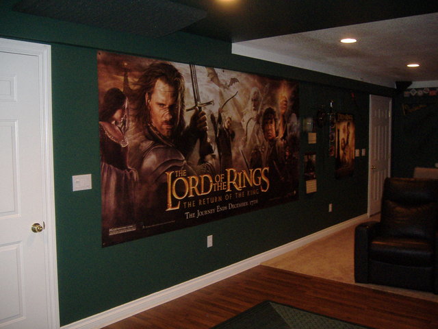 Soundroom - View of the LOTR wall with 11' theater banner of the Return of the King, with collector's plates and sword along with Theodan's sword, full collector's edition, extended edition of all 3 movies, 2 Towers poster, 2005 LOTR calender.