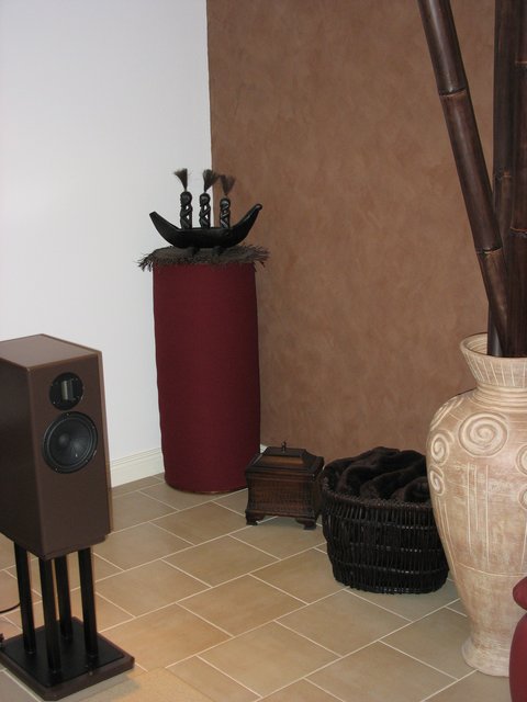 One of the corner bass traps (4'h x 18" dia.). Large sandfilled urn and large bamboo sticks block the first reflection from right wall. Left wall first reflection is attenuated by heavy curtains.