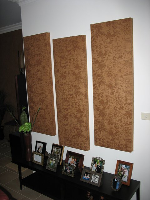 3 fabric covered absorption panels (4'6"h x 18"w x 3"d) behind listener.