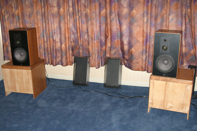 AK Member Room - Kegger - ADS speakers with hotel nightstand speaker stands.