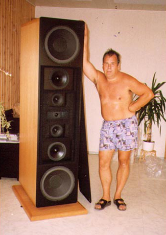 Trollish shirtless man with large tower speaker